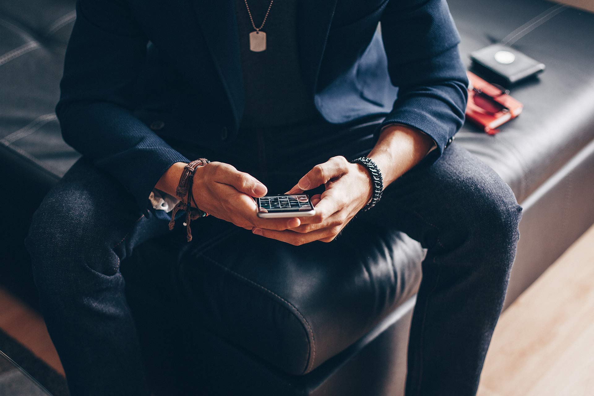 man using his iphone 6 on a sofa picjumbo com
